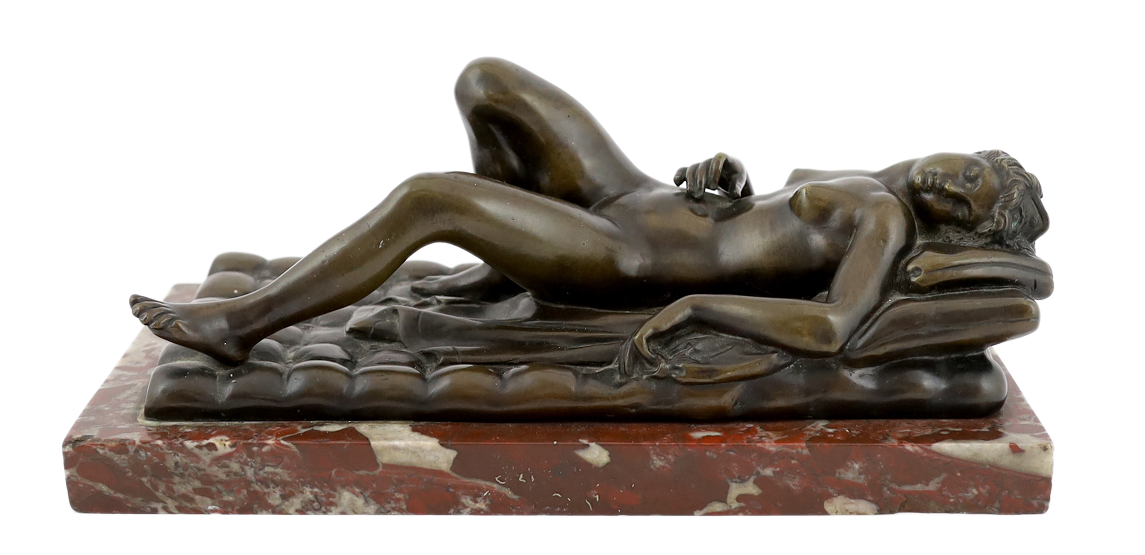 A late 19th/early 20th century bronze female nude reclining on a bed, on a red marble base, 32cm long